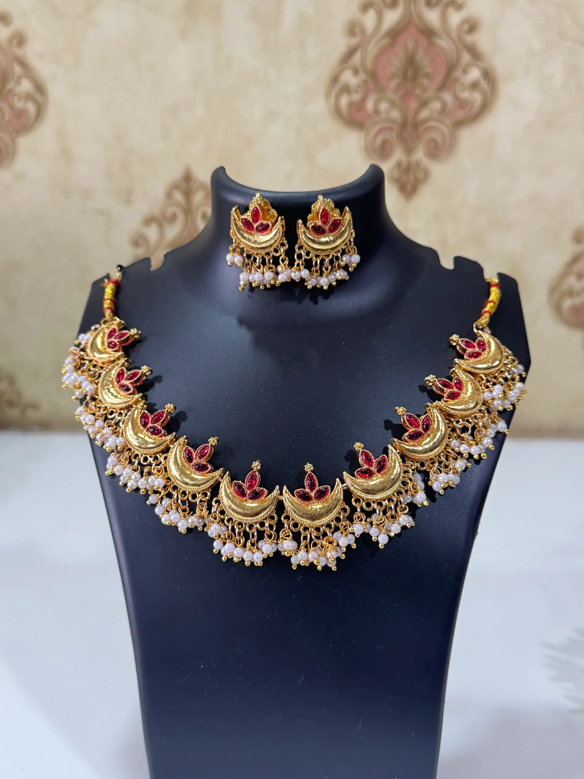 chandrakor necklace set LuxeAlankar Traditional Gold Plated Lotus Chandrakor Necklace Set with Red Green Stones and Matching Earrings