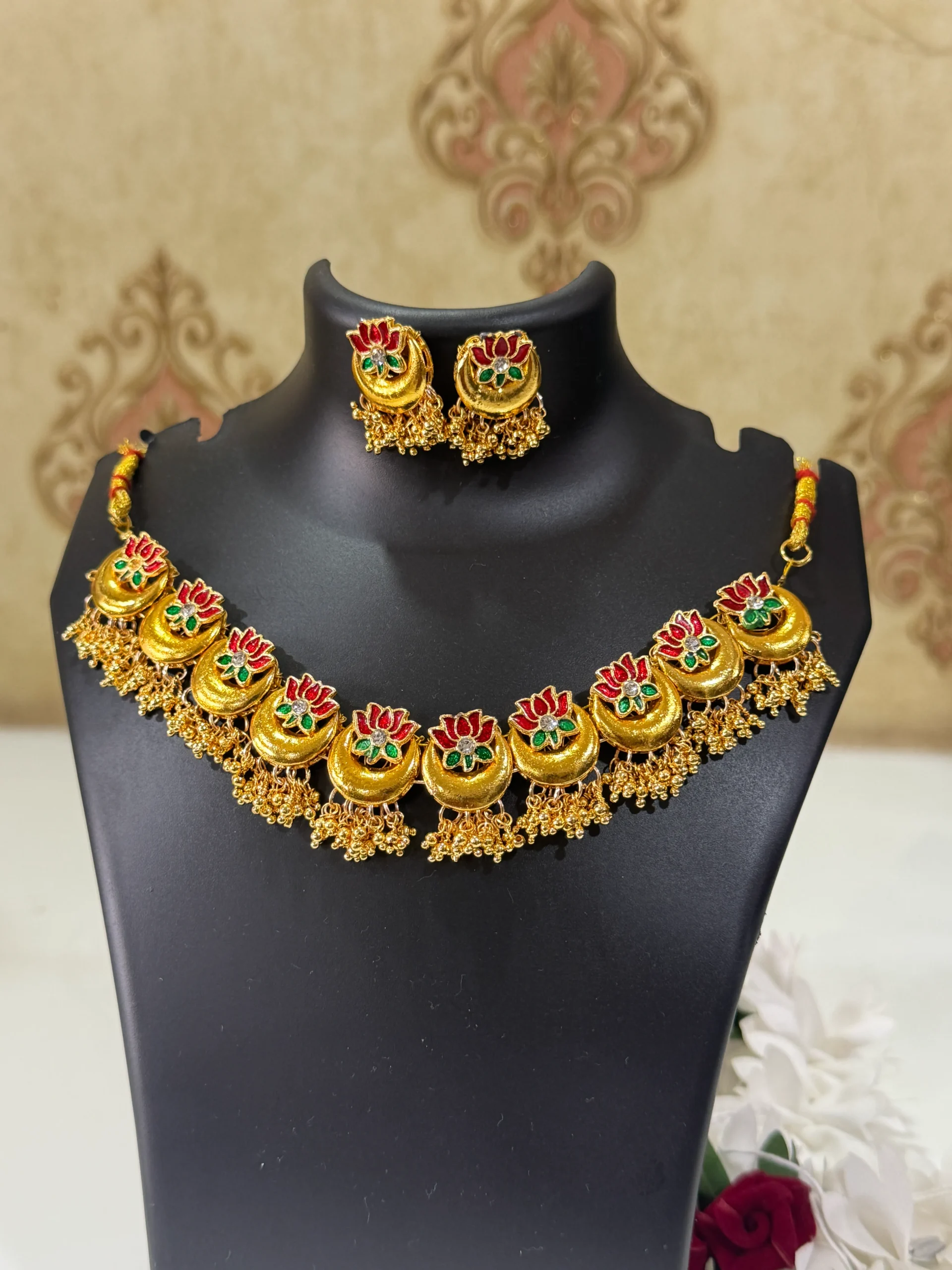lotus chandrakor necklace set LuxeAlankar Traditional Gold Plated Lotus Chandrakor Necklace Set with Red Green Stones and Matching Earrings